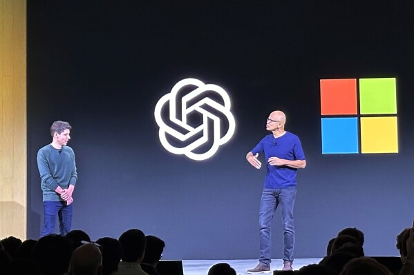 FILE - OpenAI CEO Sam Altman, left, appears onstage with Microsoft CEO Satya Nadella at OpenAI's first developer conference, on Nov. 6, 2023, in San Francisco. Microsoft has quit its seat on the board of OpenAI, saying its role is no longer needed because the ChatGPT maker has improved its governance since being roiled by boardroom chaos last year. In a letter sent on Tuesday, July 9, 2024, Microsoft confirmed it was resigning, “effective immediately,” from its role as an observer on the board. (AP Photo/Barbara Ortutay, File)