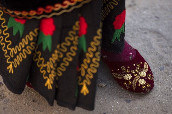 A member of Shrijanshil Mahila Sanstha, or the Self-Reliant Women’s Group, rests during a rehearsal in Kathmandu, Nepal, Thursday, March 7, 2024.  (AP Photo/Niranjan Shrestha)