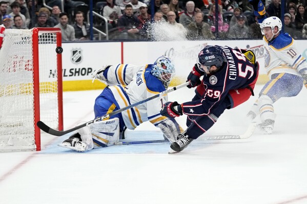 Columbus Blue Jackets right wing Yegor Chinakhov (59) shoots on Buffalo Sabres goaltender Ukko-Pekka Luukkonen (1), but the puck hits the post during the second period of an NHL hockey game Friday, Feb. 23, 2024, in Columbus, Ohio. (AP Photo/Sue Ogrocki)