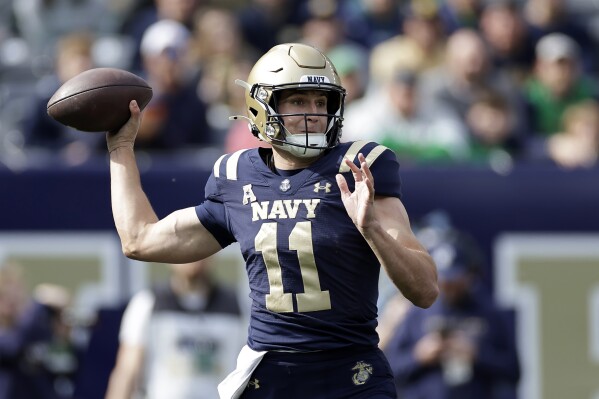 Navy quarterback Blake Horvath (11) throws a pass during the first half of an NCAA college football game against Notre Dame, Saturday, Oct. 26, 2024, in East Rutherford, N.J. (AP Photo/Adam Hunger)