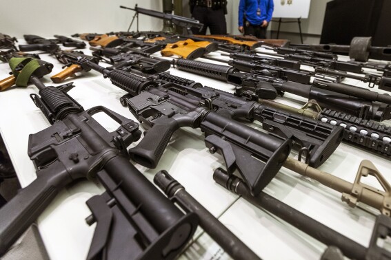 FILE - A variety of military-style semi-automatic rifles obtained during a buy back program are displayed at Los Angeles police headquarters on Dec. 27, 2012, in Los Angeles. A federal judge on Friday, Sept. 22, 2023, struck down a California law banning high-capacity magazines. (AP Photo/Damian Dovarganes, File)