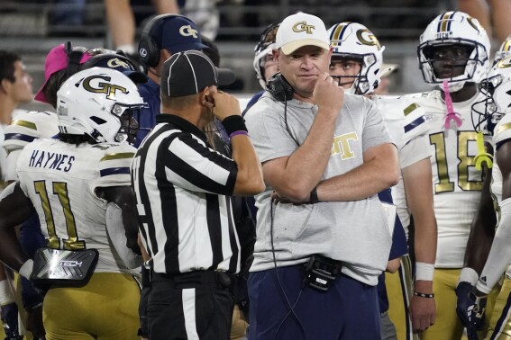 Georgia Tech coach Brent Key, right, talks with an official during the second half of the team's NCAA college football game against Wake Forest in Winston-Salem, N.C., Saturday, Sept. 23, 2023. (AP Photo/Chuck Burton)