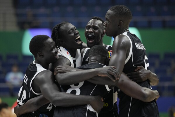 South Sudan players celebrate after winning against China during their Basketball World Cup group B match at the Araneta Coliseum in Manila, Philippines Monday, Aug. 28, 2023. (AP Photo/Aaron Favila)