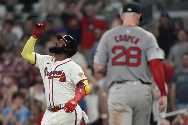 Atlanta Braves designated hitter Marcell Ozuna gestures after driving in the go ahead run with a base hit in the eighth inning of a baseball game against the Boston Red Sox Tuesday, May 7, 2024, in Atlanta. (AP Photo/John Bazemore)