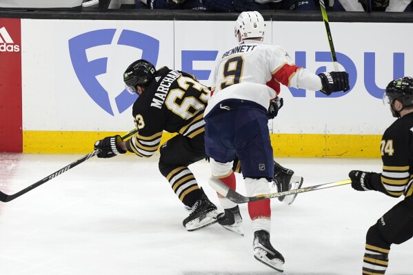Florida Panthers' Sam Bennett (9) checks Boston Bruins' Brad Marchand (63) during the first period in Game 3 of an NHL hockey Stanley Cup second-round playoff series Friday, May 10, 2024, in Boston. (AP Photo/Michael Dwyer)