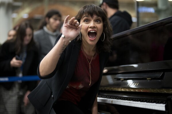Norah Jones performs during a surprise performance at Kings Cross station in London, Wednesday, March 13, 2024. (Photo by Scott Garfitt/Invision/AP)