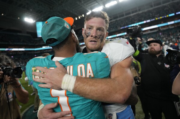 Miami Dolphins quarterback Tua Tagovailoa (1) and Tennessee Titans quarterback Will Levis hug at the end of during an NFL football game, Monday, Dec. 11, 2023, in Miami. The Titans defeated the Dolphins 28-27. (AP Photo/Rebecca Blackwell)