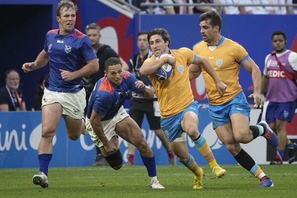Uruguay's Santiago Arata runs to score a try during the Rugby World Cup Pool A match between Uruguay and Namibia at the OL Stadium in Lyon, France, Wednesday, Sept. 27, 2023. (AP Photo/Laurent Cipriani)