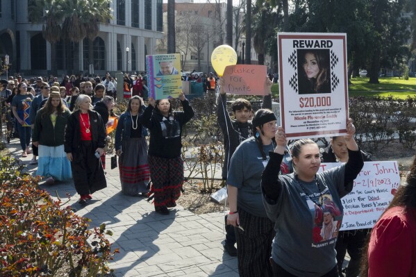 FILE - Family and friends of the missing and murdered march around the California State Capitol at the second annual Missing and Murdered Indigenous People Summit and Day of Action, Tuesday, Feb. 13, 2024, in Sacramento, Calif. Sunday, May 5, marks Missing and Murdered Indigenous Persons Awareness Day. (AP Photo/Jose Luis Villegas, File)