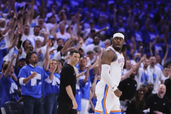 Fans cheer as Oklahoma City Thunder's Luguentz Dort celebrates sinking a three-pointer in the second half of Game 5 of an NBA basketball second-round playoff series against the Denver Nuggets Tuesday, May 13, 2025, in Oklahoma City. (AP Photo/Nate Billings)