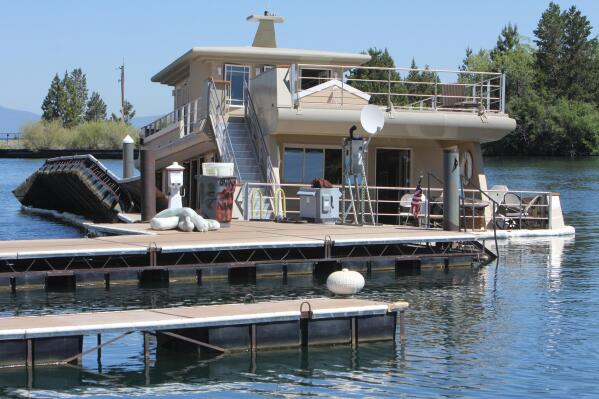 The luxury yacht the Sierra Rose, sits partially submerged at its Tahoe Keys Marina dock Monday, July 9, 2012 in South Lake Tahoe, Calif.  Witnesses say the three-story yacht that recently sold for $3.2 million hs sunk in a Lake Tahoe marina. It's not clear what sent the 86-foot Sierra Rose vessel underwater at the Tahoe Keys Marina by Monday morning, although neighbors report hearing the sound of tearing metal Sunday night. (AP Photo/ Tahoe Daily Tribune, Adam Jensen)