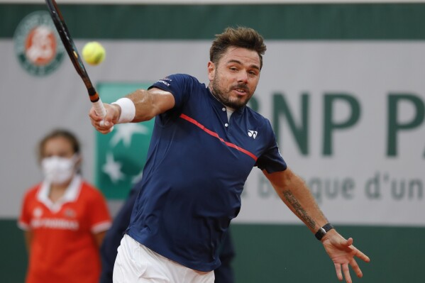 Switzerland's Stan Wawrinka plays a shot against Britain's Andy Murray in the first round match of the French Open tennis tournament at the Roland Garros stadium in Paris, France, Sunday, Sept. 27, 2020. (AP Photo/Christophe Ena, File)