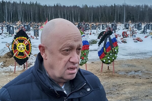 FILE - Wagner Group head Yevgeny Prigozhin attends the funeral at the Beloostrovskoye Cemetery outside St. Petersburg, Russia, on Dec. 24, 2022, of Dmitry Menshikov, one of his mercenaries who died fighting in Ukraine. Prigozhin made his name as the profane and brutal mercenary boss who in June 2023 mounted a brief armed rebellion that was the most serious challenge to the rule of Russian President Vladimir Putin. (AP Photo, File)
