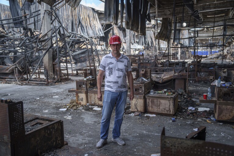 Store manager Oleksandr Lutsenko stands inside the Epicenter shopping complex in Kharkiv, Ukraine, Thursday, June 6, 2024. The Russian military's shelling of Epicenter with glide bombs in May killed 19 people , including two children.  In total, gliding bombs hit the city more than 50 times in 2024, according to Spartak Borysenko of the Kharkiv regional prosecutor's office.  (AP Photo/Evgeniy Maloletka)