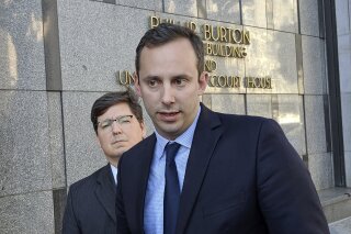 FILE - This Sept. 24, 2019 photo shows former Google engineer Anthony Levandowski, right, in front of his attorney, Miles Ehrlich, outside of a federal courthouse in San Francisco. President Donald Trump has pardoned Levandowski, who plead guilty to stealing trade secrets before joining Uber’s effort to build robotic vehicles for its ride-hailing service. Levandowski was among the more than 140 people included in a flurry of clemency action in the final hours of Trump’s White House term. (AP Photo/Michael Liedtke)