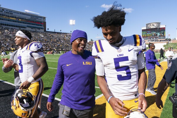 LSU quarterback Jayden Daniels, right, walks off the field after defeating Missouri 49-39 in an NCAA college football game Saturday, Oct. 7, 2023, in Columbia, Mo. (AP Photo/L.G. Patterson)