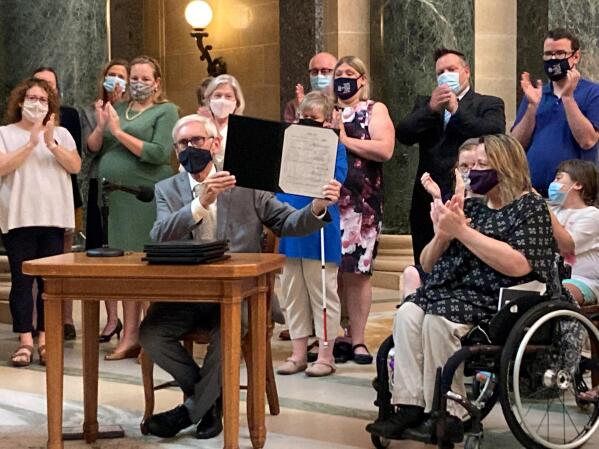 Wisconsin Gov. Tony Evers vetoes Republican bills that would have made it more difficult to vote absentee in the battleground state during a news conference in the Capitol rotunda on Tuesday, Aug. 10, 2021, in Madison, Wis. (AP Photo/Scott Bauer)