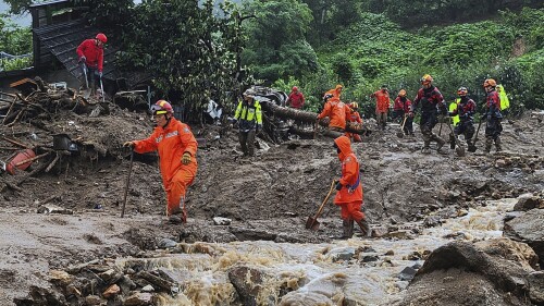 Rescue workers search for people in houses collapsed folowing a landslide caused by heavy rain in Yecheon, South Korea, Saturday, July 15, 2023. (Gyeongbuk Fire Station Service Headquarters via Yonhap AP)