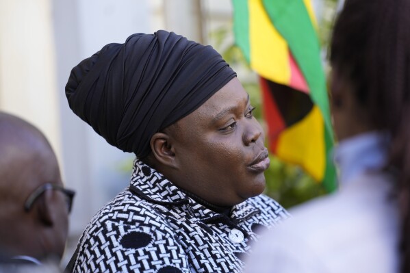 Linda Masarira, a presidential candidate speaks to the press outside the High Court in Harare, Zimbabwe, Wednesday, June, 23 2023. Masarira had her candidacy rejected because she failed to pay the $20,000 registration fee on time. In Zimbabwe, the low number of women standing as candidates in general elections scheduled for Aug. 23 is viewed as perpetuating decades-old domination of politics by men. (AP Photo/Tsvangirayi Mukwazhi)