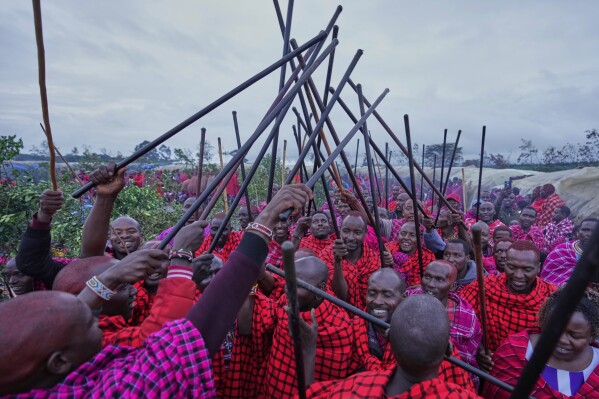 Men of the Maasai tribe perform traditional dance, during a Maasai male rite of passage, specifically the initiation of boys, marking the transition from childhood to becoming a moran (warrior) in Olaimutiai, Narok County, Kenya Wednesday, April 23, 2024. (AP Photo/Brian Inganga)