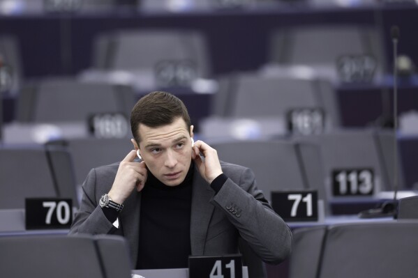 FILE - French Far-right party National Rally president Jordan Bardella attends a session at the European Parliament, Tuesday, Jan. 16, 2024 in Strasbourg, eastern France. At just 28 years old, Jordan Bardella has led the French far right to a landslide victory in the European Parliament election in June. After voters propelled Marine Le Pen's National Rally to a strong lead in the first round of national legislative elections on Sunday, Bardella has turned to rallying supporters to grant Marine Le Pen's party an absolute majority in the decisive round of voting on July 7 and make him the prime minister of France. (AP Photo/Jean-Francois Badias, File)