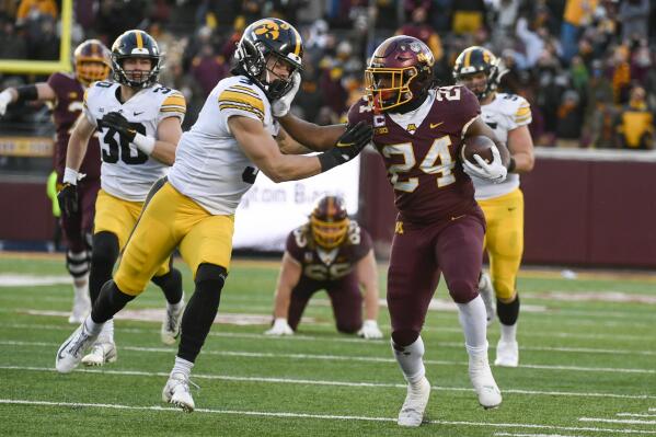 Minnesota running back Mohamed Ibrahim (24) stiff-arms Iowa defensive back Cooper DeJean (3) during the first half an NCAA college football game on Saturday, Nov. 19, 2022, in Minneapolis. (AP Photo/Craig Lassig)