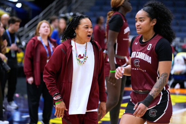 South Carolina head coach Dawn Staley talks to guard Te-Hina Paopao (0) during practice at the Final Four of the NCAA college basketball tournament Thursday, April 3, 2025, in Tampa, Fla. (AP Photo/Chris O'Meara)