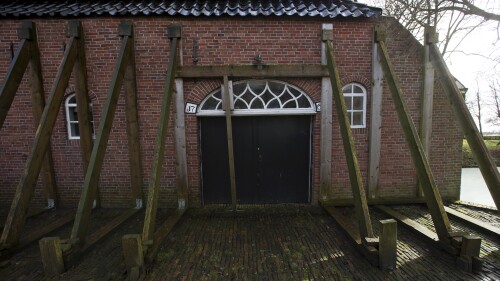 FILE - Support beams stabilize an historic farm in Hunzinge, northern Netherlands, on Jan. 19, 2018. Extraction from one of the world's largest natural gas fields will end in October, the Dutch government announced Friday, June 23, 2023 turning off a lucrative tap that has also sparked unrest by causing a string of earthquakes. (AP Photo/Peter Dejong, File)