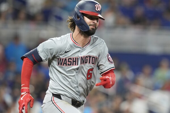 Washington Nationals' Jesse Winker (6) runs to first base after hitting a single during the sixth inning of a baseball game against the Miami Marlins, Saturday, April 27, 2024, in Miami. (AP Photo/Marta Lavandier)