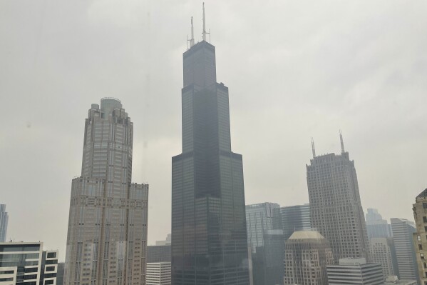 FILE - The Willis Tower (formerly Sears Tower) is pictured in downtown Chicago, where the air quality has been categorized "unhealthy" by the U.S. Environmental Protection Agency, on June 27, 2023. The EPA says extensive swaths of the northern United States awoke to unhealthy air quality Monday, July 17, or were experiencing it by midafternoon. Fine particle pollution caused by smoke from Canada’s wildfires is causing a red zone air quality index, meaning it is unhealthy for everyone. (AP Photo/Claire Savage, file)