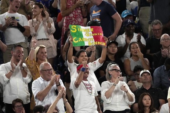 Fans react during during the men's singles final match between Jannik Sinner of Italy and Daniil Medvedev of Russia at the Australian Open tennis championships at Melbourne Park, in Melbourne, Australia, Sunday, Jan. 28, 2024. (AP Photo/Alessandra Tarantino)