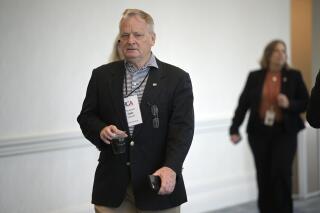 North Carolina State Treasurer Dale Folwell walks through the Republican Governors Association conference, Wednesday, Nov. 16, 2022, in Orlando, Fla. North Carolina agencies and state pension plans would be prohibited from using socially and environmentally conscious criteria to make investment decisions or hire employees, under legislation that advanced Wednesday through a state Senate committee. (AP Photo/Phelan M. Ebenhack)
