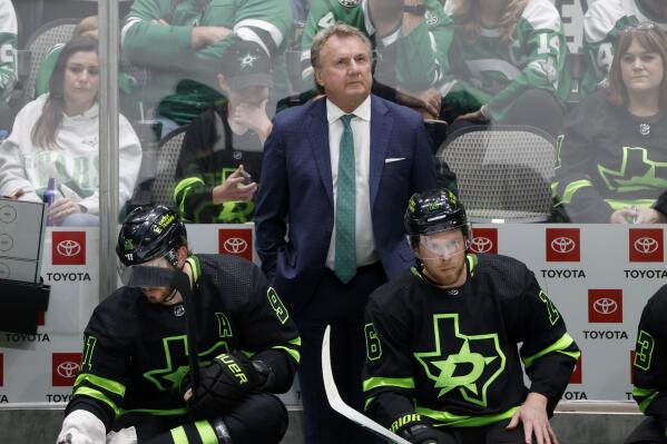 Dallas Stars head coach Rick Bowness, top center, center Tyler Seguin (91) and center Joe Pavelski (16) watch from the bench as they play the San Jose Sharks during the third period of an NHL hockey game in Dallas, Saturday, April 16, 2022. (AP Photo/Michael Ainsworth)