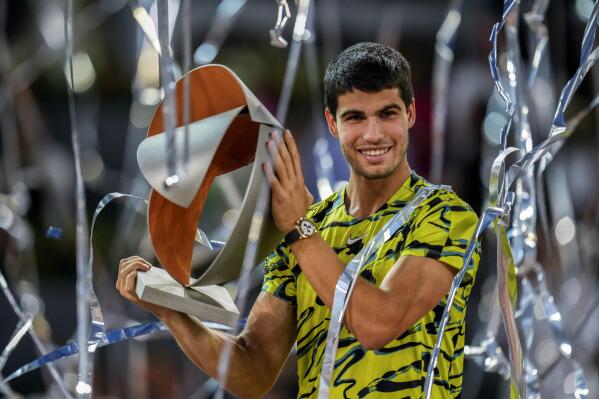Carlos Alcaraz, of Spain, holds the winner's trophy after defeating Jan-Lennard Struff, of Germany, in the men's final at the Madrid Open tennis tournament in Madrid, Spain, Sunday, May 7, 2023. (AP Photo/Manu Fernandez)