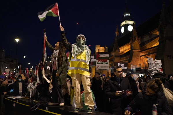 FILE - Protesters wave flags during a pro-Palestinian protest in front of the Houses of Parliament in London on Nov. 15, 2023. (AP Photo/Alberto Pezzali, File)