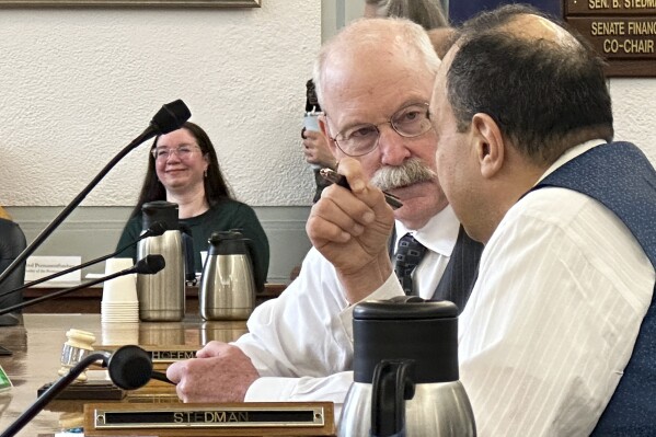 Alaska Republican state Sen. Bert Stedman speaks with state Sen. Donny Olson, a Democrat, at a budget conference committee meeting on Tuesday, May 14, 2024, in Juneau, Alaska. House and Senate budget negotiators on Tuesday announced a tentative budget agreement. (AP Photo/Becky Bohrer)