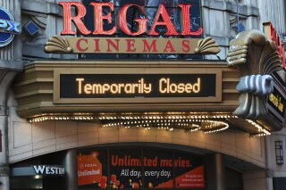 Regal Cinemas on 42nd Street is temporarily closed due to COVID-19 on March 5, 2021, in New York. Regal Cinemas, the second largest movie theater chain in the U.S., will reopen beginning April 2, its parent company, Cineworld Group, announced Tuesday. (Photo by Evan Agostini/Invision/AP)