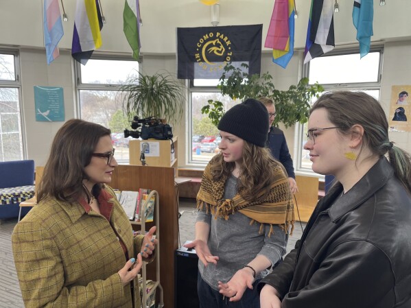 Bloomington Jefferson senior Shae Ross, center, joined Lieutenant Governor Peggy Flanagan, left, at an event promoting proposed legislation to prevent books bans based on ideology at Como Park High School in St. Paul, Minn., on March 21, 2024. (Chris Williams/Education Minnesota via AP)