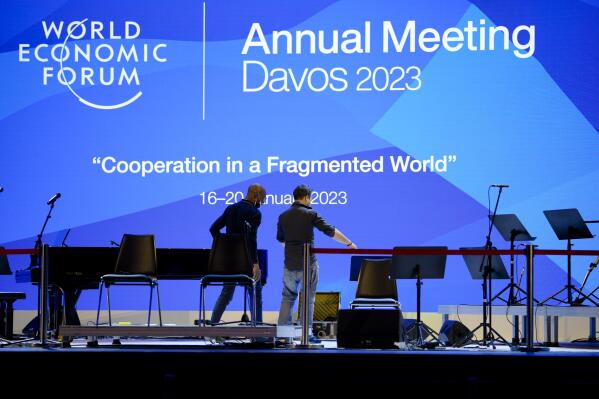 People set up the stage at the eve of the opening of the World Economic Forum in Davos, Switzerland, Sunday, Jan. 15, 2023. The annual meeting of the World Economic Forum is taking place in Davos from Jan. 16 until Jan. 20, 2023. (AP Photo/Markus Schreiber)
