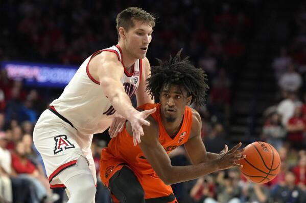 Oregon State forward Glenn Taylor Jr., right, shields the ball from Arizona forward Azuolas Tubelis during the first half of an NCAA college basketball game, Saturday, Feb. 4, 2023, in Tucson, Ariz. (AP Photo/Rick Scuteri)