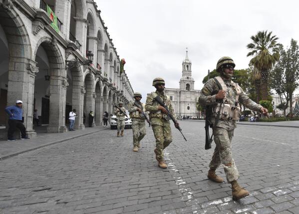 Soldiers patrol in Arequipa, Peru, Wednesday, Dec. 14, 2022. Peru’s new government declared a 30-day national emergency on Wednesday amid violent protests following the ouster of President Pedro Castillo, suspending the rights of “personal security and freedom” across the Andean nation. (AP Photo/Jose Sotomayor)