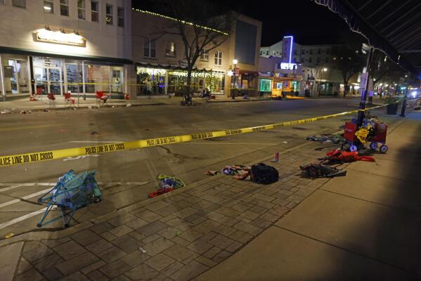 Police tape cordons off a street in Waukesha, Wis., after an SUV plowed into a Christmas parade hitting multiple people Sunday, Nov. 21, 2021. (AP Photo/Jeffrey Phelps)