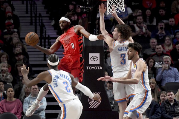 Portland Trail Blazers forward Jerami Grant, second form left, looks to pass the ball as Oklahoma City Thunder guard Shai Gilgeous-Alexander, left, guard Josh Giddey, second from right, and forward Chet Holmgren, right defend during the first half of an NBA basketball game in Portland, Ore., Wednesday, March 6, 2024. (AP Photo/Steve Dykes)