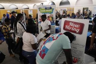 FILE - Job applicants fill out forms with CSC Global, left, and Skilled Staffing, right, at the 305 Second Chance Job & Resource Expo, Friday, June 10, 2022, in Miami. America’s employers shrugged off high inflation and weakening growth to add 372,000 jobs in June, a surprisingly strong gain that will likely spur the Federal Reserve to keep sharply raising interest rates to try to cool the economy and slow price increases. The unemployment rate remained at 3.6% for a fourth straight month, the government said Friday, July 8. (AP Photo/Lynne Sladky, File)