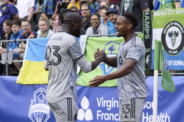 CF Montréal's Kei Kamara (23) celebrates with Mason Toye (13) after Toye scored against the Seattle Sounders during the first half of an MLS soccer match Wednesday, June 29, 2022, in Seattle. (AP Photo/John Froschauer)