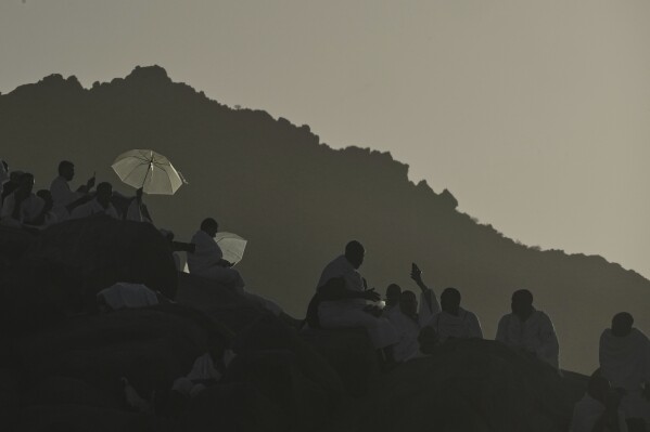Muslim pilgrims gather a top of the rocky hill known as the Mountain of Mercy, on the Plain of Arafat, during the annual Hajj pilgrimage near the holy city of Mecca, Saudi Arabia, Thursday, June 5, 2025. (AP Photo/Amr Nabil)
