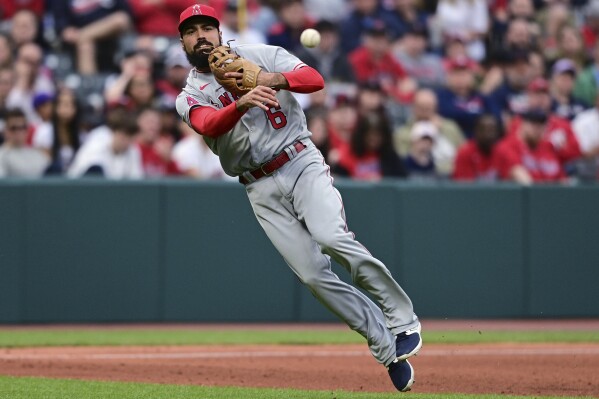 FILE - Los Angeles Angels third baseman Anthony Rendon throws to first for the out on Cleveland Guardians' Cam Gallagher during the fifth inning of a baseball game May 13, 2023, in Cleveland. Rendon says his leg injury is a fractured tibia, not a deep bone bruise. Rendon gave a rare update to reporters Friday, Sept. 15, at Angel Stadium, although he didn’t say whether he’ll be able to return this season. The $245 million slugger has been sidelined since July 4 with the latest injury in his extensive history. (AP Photo/David Dermer, File)
