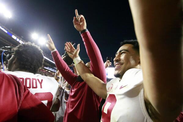 Alabama quarterback Bryce Young (9) celebrates after defeating Auburn during the fourth overtime of an NCAA college football game Saturday, Nov. 27, 2021, in Auburn, Ala. Alabama won 24-22. (AP Photo/Butch Dill)