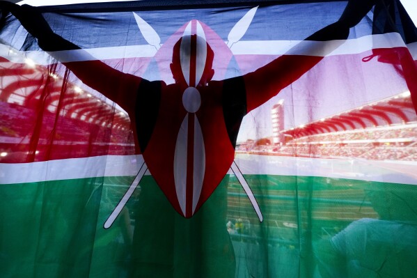 FILE - A fan of Kenya holds up a national flag during the final in the women's 5000-meter run at the World Athletics Championships on July 23, 2022, in Eugene, Ore. Kenya has achieved unparalleled success in modern distance running, but a wave of positive drug tests over the last decade has ruined that reputation, made it the sport's latest doping pariah, and pushed it to the brink of a sweeping international ban that would sit it alongside Russia. (AP Photo/Gregory Bull, File)