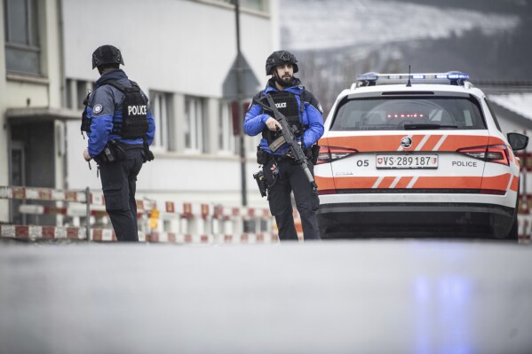 Police at the scene after a shooting incident, in Sion, Switzerland, Monday, Dec. 11, 2023. Police say two people have been killed and one wounded after a gunman fired shots at two locations in a southern Swiss town. They said the man opened fire on several people in Sion shortly before 8 a.m. Monday for reasons that aren’t yet clear. (Louis Dasselborne/Keystone via AP)